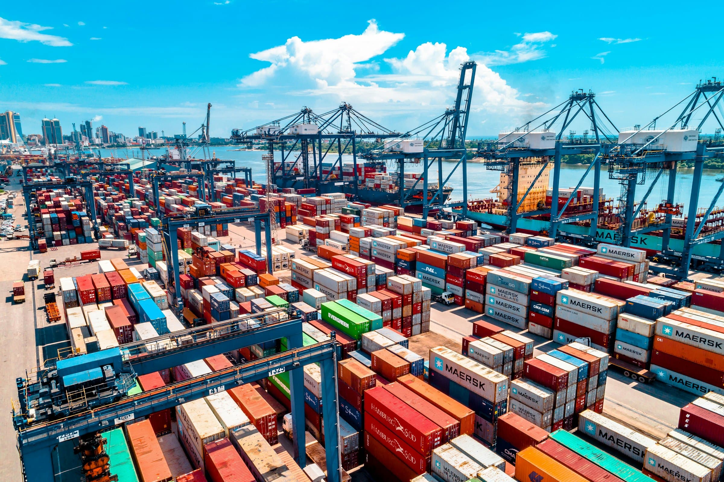 Stacked containers and cranes at a port